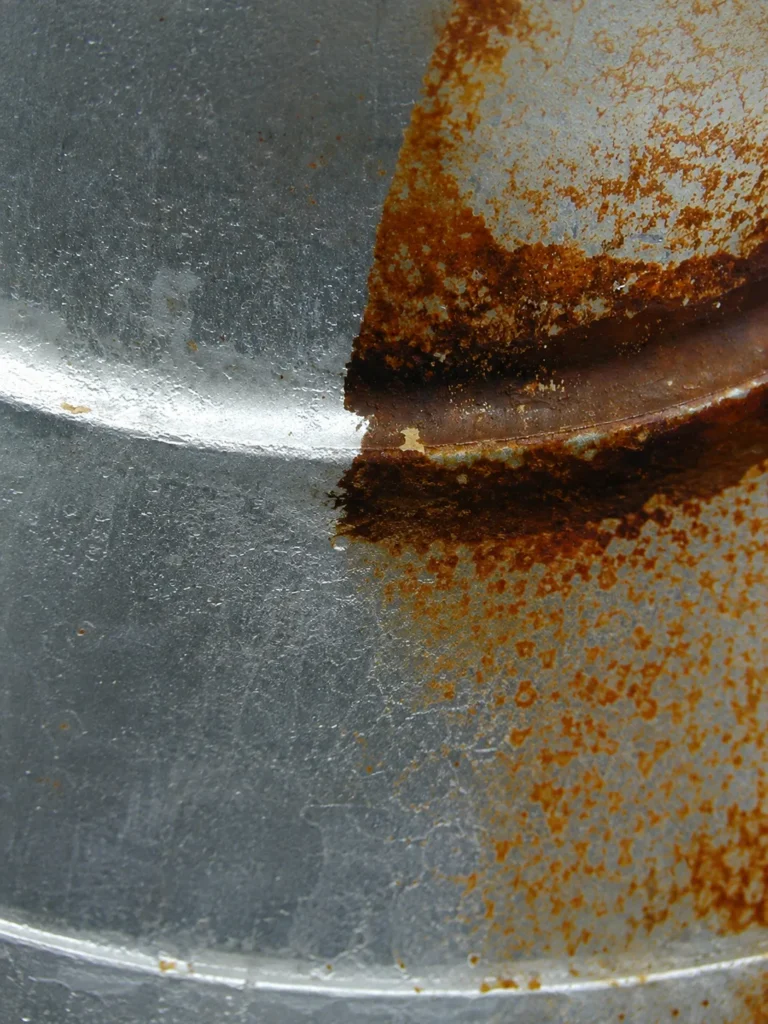 Steel surface with rust removed from one half