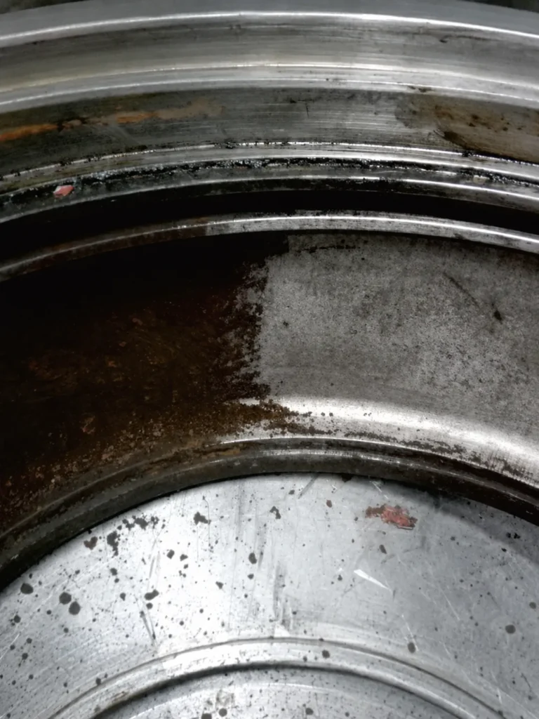 Steel drum interior with rust cleaned from one side