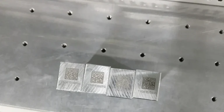 Laser-marked 2D codes and serial numbers on metal plates